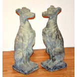 A pair of garden stoneware seated dogs,