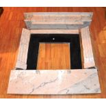 A marble fireplace, with plinth shaped canopy top above black marble insert and mottled base,
