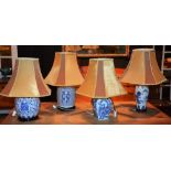 Four 20th century Chinese blue and white pottery table lamps, with shades,