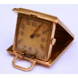 A 14ct gold engine turned travel clock by Eszeha, stamped 585 to case, with carry handle,