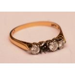 An 18ct gold and platinum four stone diamond ring, (one stone missing),