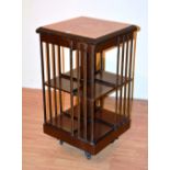 An Edwardian mahogany inlaid revolving bookcase,