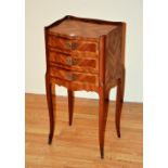 A French Louis XVI style bedside cabinet, with three graduated drawers,