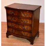 A reproduction mahogany serpentine chest of drawers, with four graduated drawers,