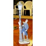 A Lladro figure group, of a man standing next to a street lamp,