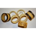 Five assorted Chinese and Japanese carved ivory napkin rings, 5 & 6cm diameter,