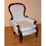 A Victorian mahogany framed armchair, upholstered in later white foliate velour,