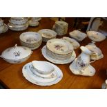 A Royal Copenhagen dinner set, decorated with colourful floral panels, on ivory coloured grounds,