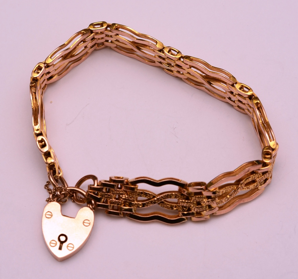 A 9ct gold padlock bracelet, with brick and cross link decoration, stamped 9ct to padlock,