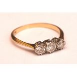 An 18ct gold three stone diamond ring, the three brilliant cut diamonds measuring approximately 0.