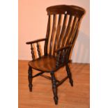 A late 19th/early 20th century vintage high backed elm country armchair, with bar back rails,