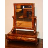 A Victorian mahogany toilet mirror, with two drawers, raised on circular feet,