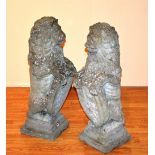 A pair of garden stoneware recumbent lion figures,