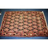 A Persian floor rug, decorated with six rows of six gull motifs, on blue ground, red foliate border,