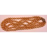 A triple strand of faux pearls, with 9ct gold genuine pearl clasp,