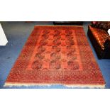 An Afghan rug, decorated with three rows of six octagonal motifs,