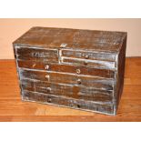 A wooden collectors chest, of small proportions, with fitted drawers,
