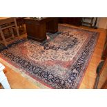 A Persian style machine made carpet, decorated with large geometric motif to the centre,