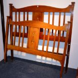 An Art Nouveau mahogany inlaid double bed,