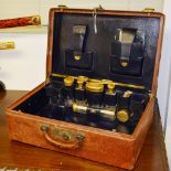 A vintage gentleman's part travel toilet set, in fitted leather case, early part of 20th century,
