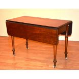 A Victorian mahogany Pembroke table, raised on spindle supports,