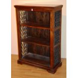 A modern hardwood open bookcase, decorated with pierced metal grills,