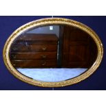 A giltwood oval wall mirror, circa early part of the 20th century,