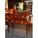 An Edwardian mahogany inlaid dressing table, with two short drawers above two longer drawers,