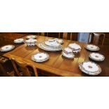 A pottery dinner service by John Maddock & Sons, decorated with floral panels on a white ground,