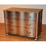 A contemporary serpentine gold painted chest of drawers, with three shaped drawers,