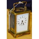 A French brass carriage clock, with single train movement, white enamel dial, and carry handle,