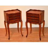 A pair of French style bedside cabinets, with tray tops, raised on cabriole supports,