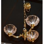 A brass three branch electrolier, with three heavy glass fluted shades,