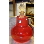 A large vintage glass chemist jar with stopper, jar full with rose water,