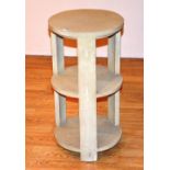 A contemporary faux shagreen circular plant stand, with three open tiers,