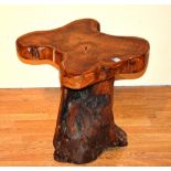 A rustic burr wood stool, with shaped top,