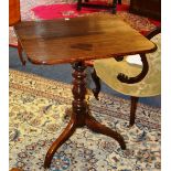 A 19th century mahogany snap top tripod table, raised on turned column,