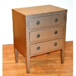 A contemporary gold painted chest of drawers, with three graduated drawers,