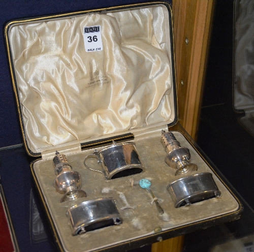 A silver five piece condiment set, hallmarks for Sheffield, with blue glass liners,