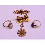 A nine carat gold bow brooch with spiders web pendant,