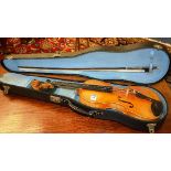 A Stradivarius copy violin with bow in fitted case, accessories in case,