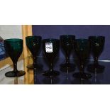 A set of six regency green glass wine glasses, circa 1820, raised on plain stem and circular foot,