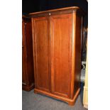 A modern wardrobe, with moulde cornice above two panelled doors,