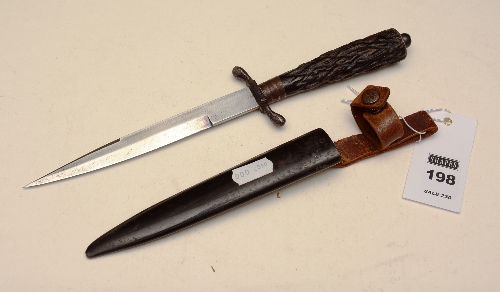 A WWI German officer's trench knife, with flat pommel, horn grip, and metal sheath,