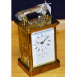 A brass carriage clock by Mathew Norman London, with carry handle and key,