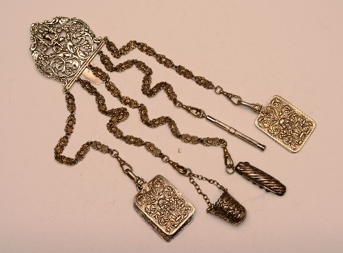 A Victorian plated chatelaine, with ornate foliate decoration and five drop chains bearing penknife,