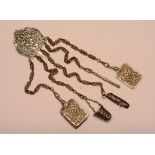 A Victorian plated chatelaine, with ornate foliate decoration and five drop chains bearing penknife,