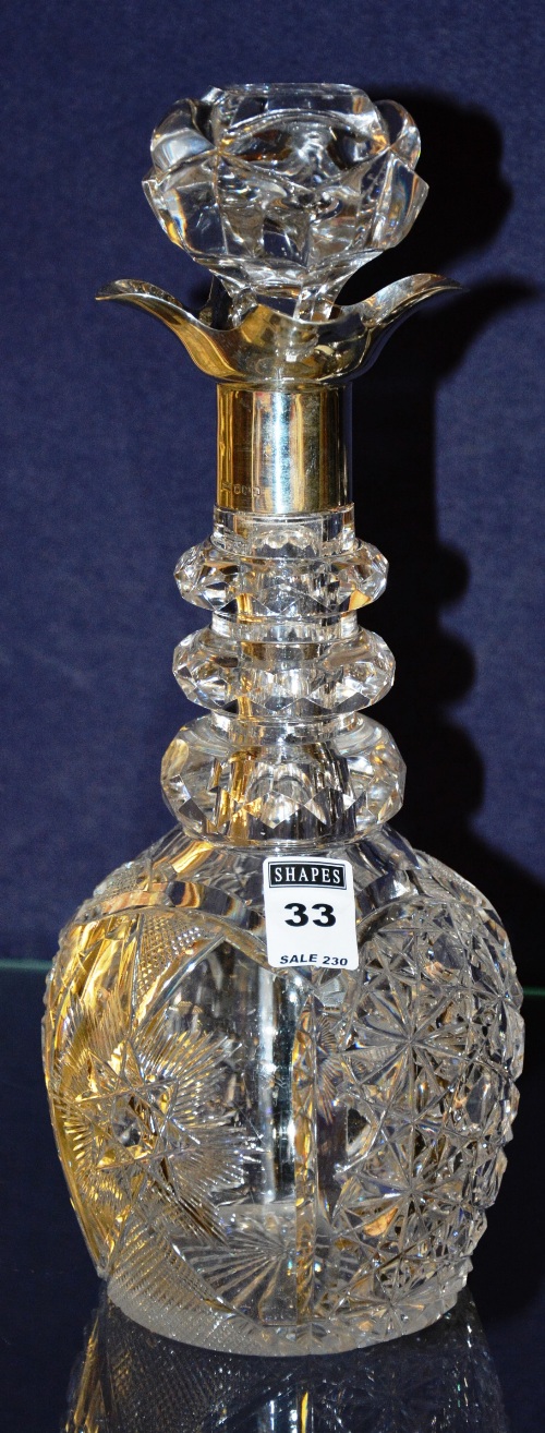 A crystal decanter with silver collar, hallmarks for Sheffield, with mushroom shaped stopper,