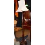 A stained wood floor lamp with shade,