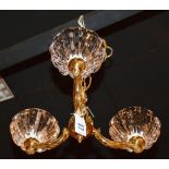 A brass three branch electrolier, with three heavy glass fluted shades,
